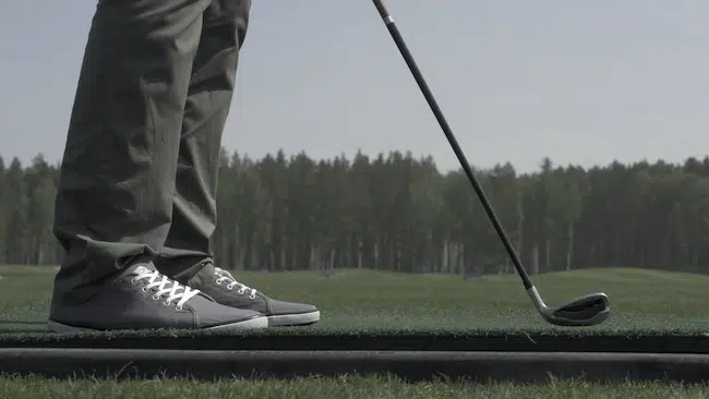 Golfer hitting a ball with a club on a beautiful golf co-2022-12-03-06-36-04-utc